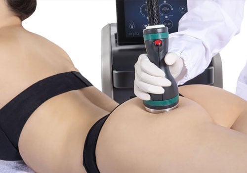 specialist using onda device on female patient