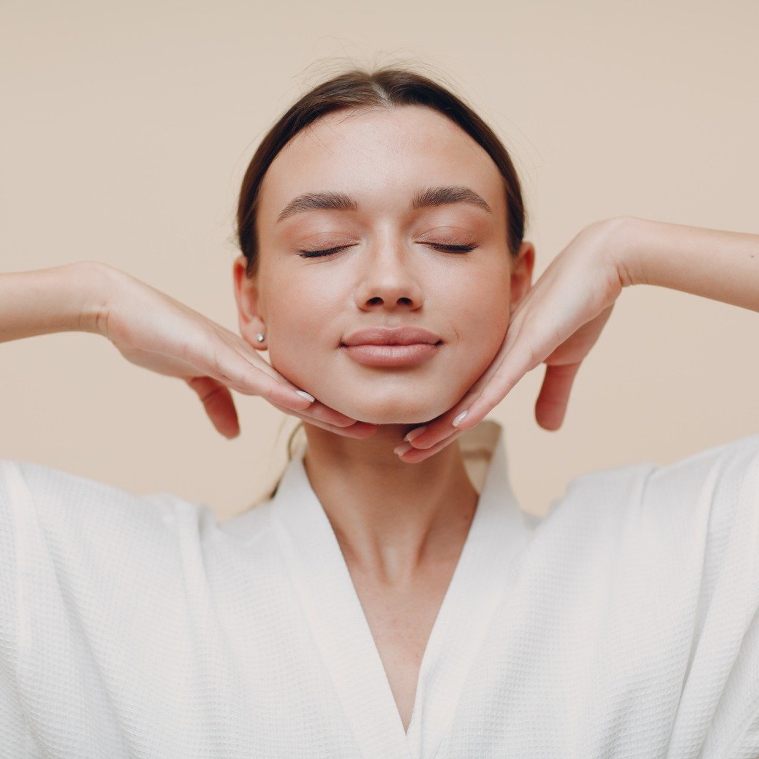 Younger woman feeling face and tight skin